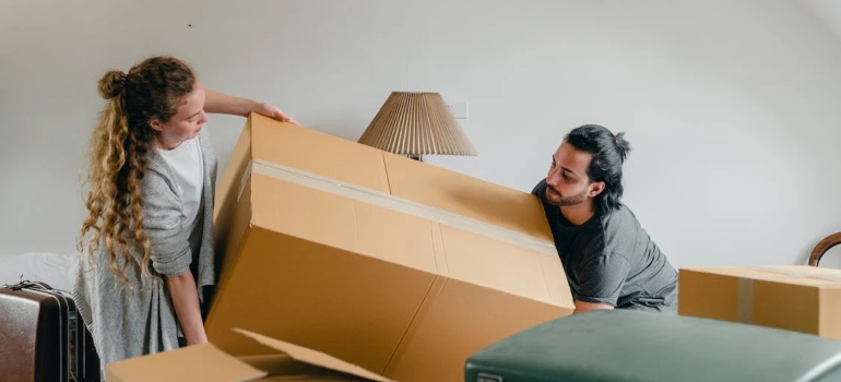 a couple carrying a box