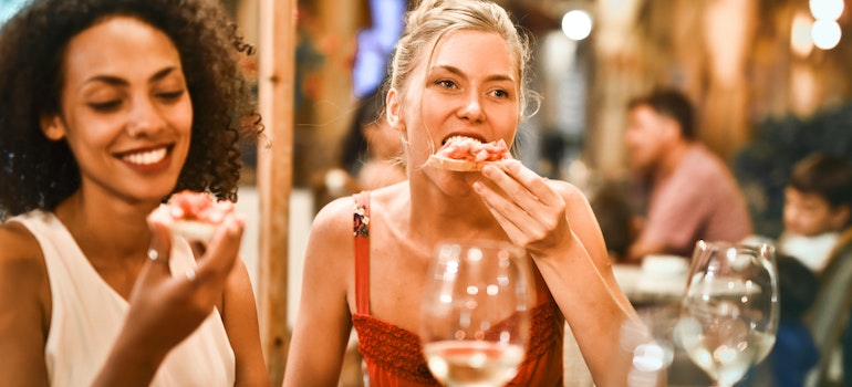 Girls eating bruscetta at one of the places to eat in the Financial District NYC.