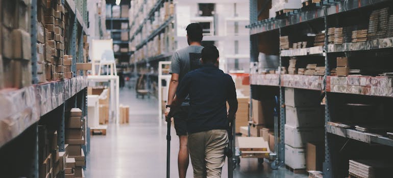 Two men walking around a warehouse