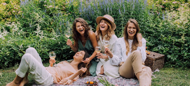 Friends at a picnic discussing lesser known neighborhoods to live in Manhattan