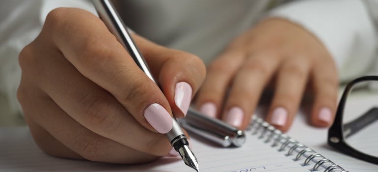 A person writing down a plan for a move