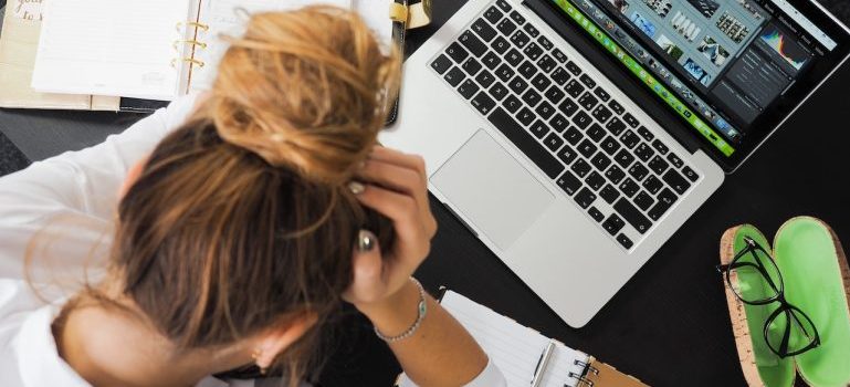 A woman sitting in front of mac book