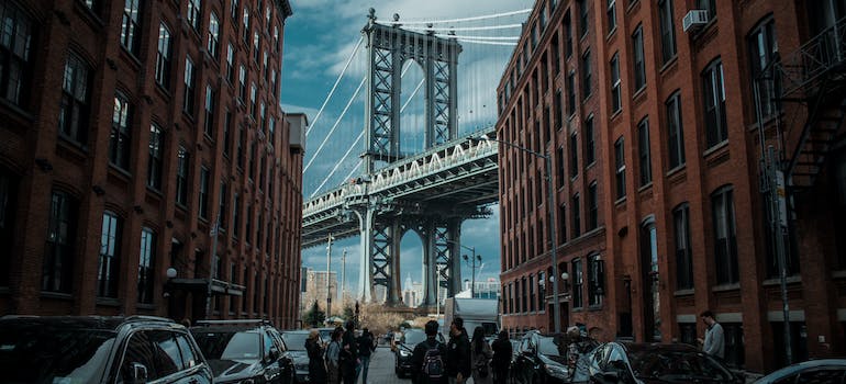 People walking on street near the bridge