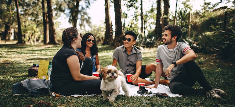 Friends on a picnic at the park in one of the Manhattan neighborhoods for young couples