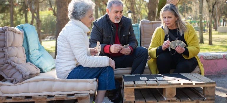 Seniors playing cards at the park