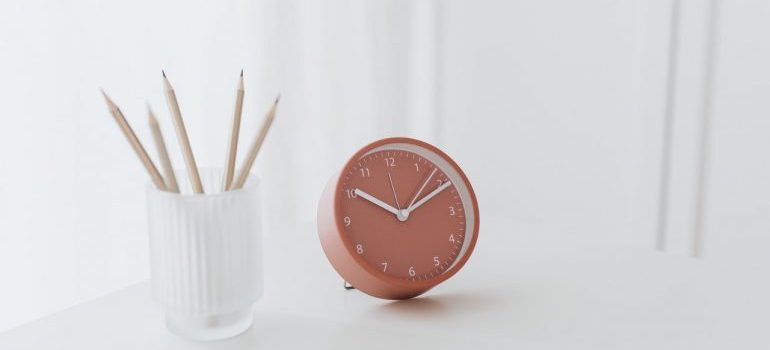 A clock on a white table
