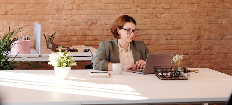 A person using their laptop to look up options for storing office equipment in a Manhattan storage unit