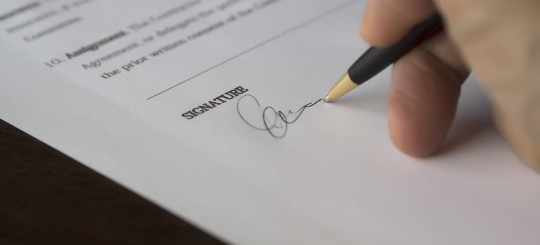 a person signing paper