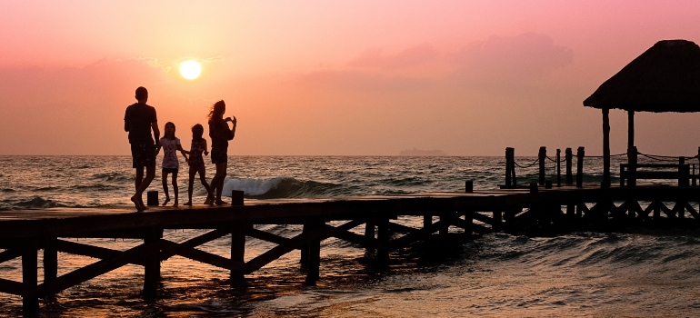 Family on a dock during a sunset