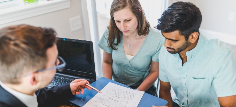 A couple talking to a real estate agent